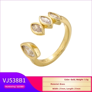 Detailed close-up of gold brass open ring featuring four marquise-cut clear crystals