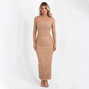 Detail of the sheer mesh sleeves and ruched body of this beige bodycon dress