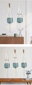 Detail of macrame plant hanger with blue ceramic pot, wooden beads, and decorative tassels