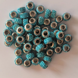 Pile of sparkling blue rhinestone clay beads for DIY jewelry with large holes