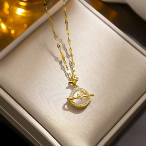 Gold titanium planet necklace with cat eye stone and zircons in a jewelry box