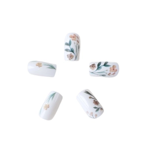 Floral press-on nails with green leaves and white base in a pastoral aesthetic style