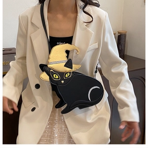 Detail of black cat shaped PU leather crossbody bag with golden sequined witch hat
