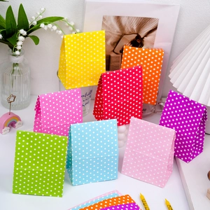 Colorful mini paper gift bags with white polka dots for festive party packaging
