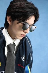 Close-up of polarized half-rim sunglasses with silver and amber frame on a model