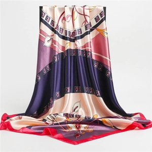 Detail of satin square scarf showing vibrant calla lily patterns and soft silky texture