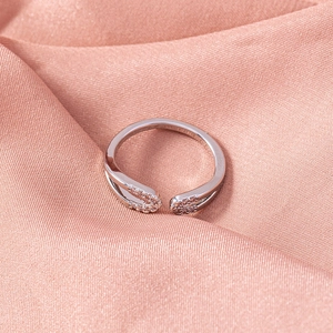 Top view of a silver double-line open ring with micro-inlaid zircons on satin cloth
