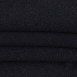 Close-up of the black lace fabric texture and detailed fiber weave on the camisole