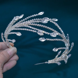 Close-up of silver bridal headband with flowing rhinestones and teardrop crystals