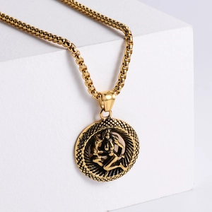 Macro detail of 18K gold-plated zodiac pendant on box chain with mythical relief