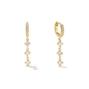 Detailed macro of gold hoop earrings with zircon fringe and four-prong settings