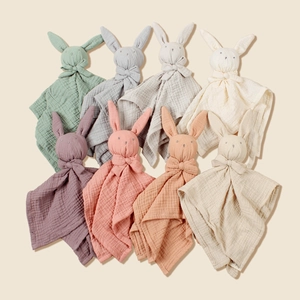 Close-up of eight multicolored cotton muslin bunny comforters for newborn babies