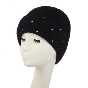Chic black knitted winter hat for women with elegant pearl accents on a display head