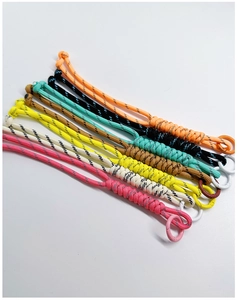 Detailed view of colorful handmade braided paracord keychains with metal rings
