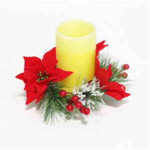Christmas wreath candle ring with red poinsettia and pine needles with LED pillar candle
