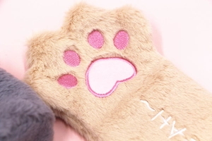 Close-up of khaki plush cat paw gloves with pink embroidered 3D kitten pads