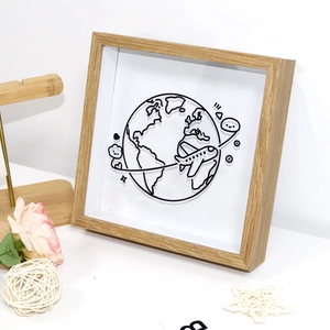 Detail view of 3D globe and airplane wireframe inside a wooden memory shadow box