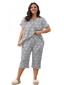 Detail of grey star print pajama set showing short sleeve top and drawstring cropped pants