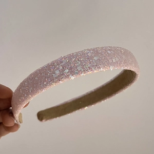 Detail showing the pink sequined fabric headband with shiny glitter and geometric sparkles