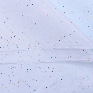 Detail of white tissue paper with colorful glitter sequins for floral bouquet wrapping