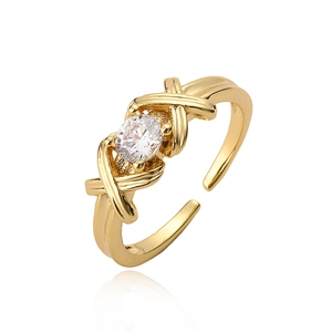 Minimalist gold-plated knot open ring with clear zircon stone on a white background