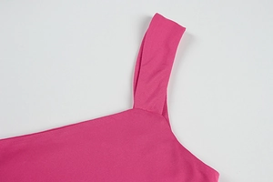 Close-up of wide shoulder straps and flat neckline on a rose pink backless maxi dress