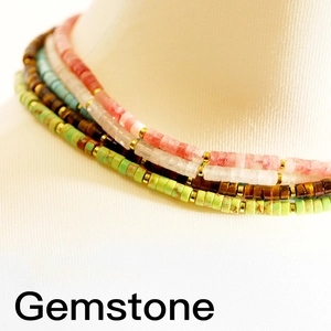 Close-up of bohemian gemstone beaded necklaces with turquoise and amethyst discs