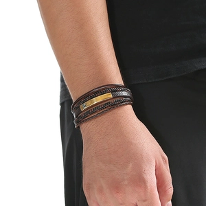 Close-up of men's multi-layer brown braided leather bracelet with golden steel plate