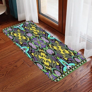 Detail of bohemian mandala flannel floor mat on dark wood floor with natural sunlight