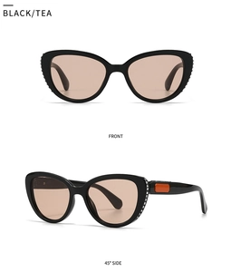 Detail view of black cat eye sunglasses with tea lenses and crystal side embellishments