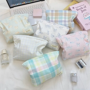 Detailed flat lay of 6-piece cotton makeup bag set with grid and cat patterns