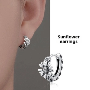 Detailed view of vintage silver sunflower earrings showing model fit and macro textures