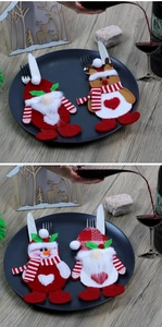 Detail of Christmas cutlery holders featuring Santa Claus and reindeer on a table setting