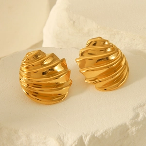 18k gold plated stainless steel spiral twisted earrings on a textured stone surface