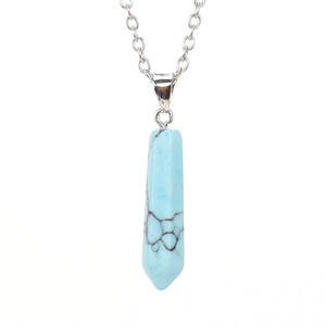 Detailed close-up of turquoise hexagonal prism pendant with silver chain necklace