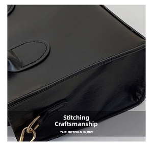 Detailed macro view showing the precise stitching craftsmanship on the black leather bag