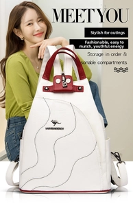 Close-up of contrast color backpack with metal kangaroo logo and red trim detail