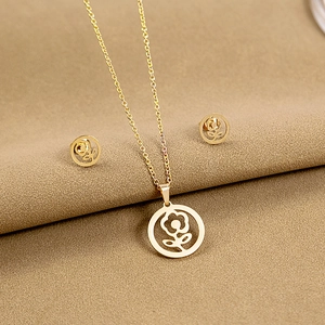Detailed close-up of golden hollow flower necklace and matching stud earrings set