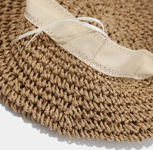 Detail of straw beret hat interior with sweatband and adjustable drawstring for fit