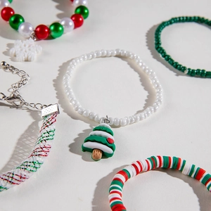 Detailed view of five-piece Christmas charm bracelet set with beads and holiday pendants