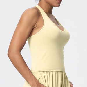 Detail of the high-elasticity fabric and slim fit design on a pale yellow sports bra
