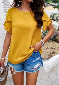 Detail of yellow short-sleeved blouse with Swiss dot texture and ruffle cuff sleeves