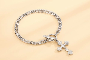 Detail of silver double-strand bracelet with OT clasp and vintage rose cross pendant