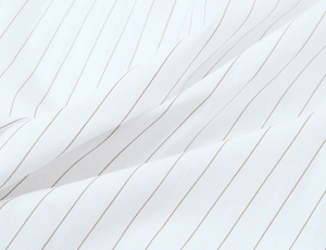 Detailed close-up of white striped fabric with soft drapes and high quality texture