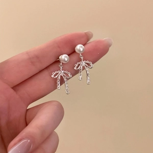 Silver bow pearl drop earrings with minimalist design and dainty aesthetic for women