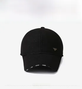 Close-up of a black winter baseball cap brim featuring white Sport text and metal logo