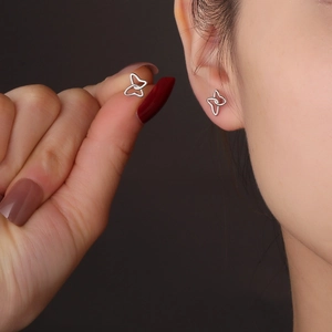 Minimalist s925 silver butterfly line stud earrings shown held by fingers for size