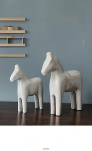 Detail of two vintage-style wooden rocking horse statues with striped texture