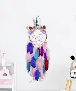 Detail of unicorn dream catcher with colorful feathers and floral decorations