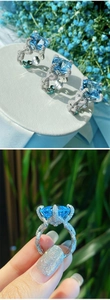 Macro detail of high-end Asscher cut blue topaz ring with pave setting and pavé side view